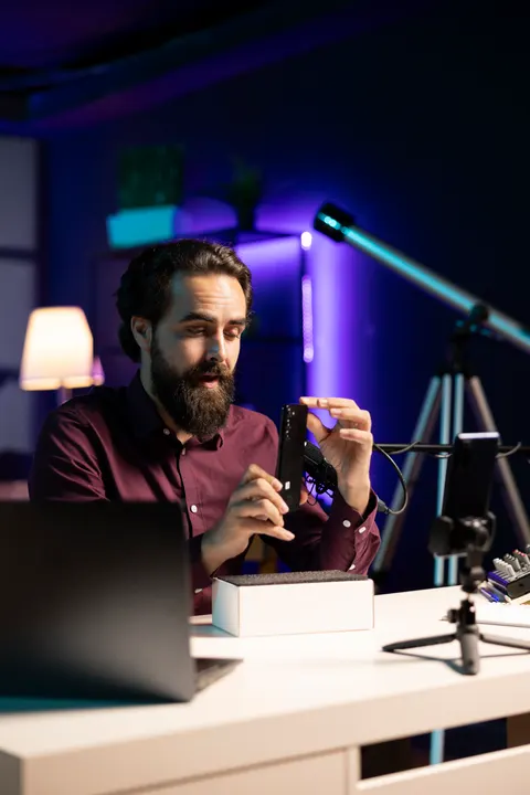 A presenter holding a product up to camera while recording a walkthrough